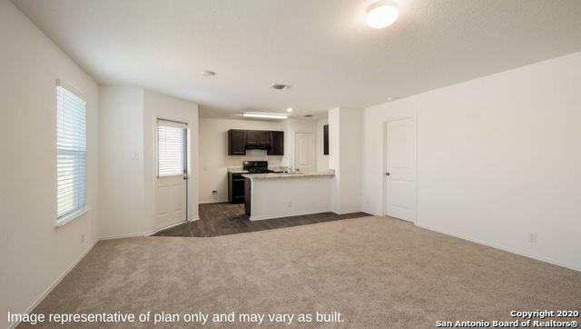 kitchen with dark brown cabinetry, kitchen peninsula, and dark carpet