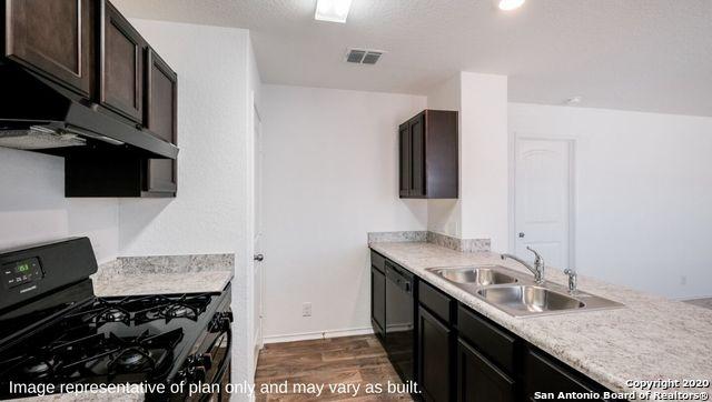 kitchen featuring black appliances, dark hardwood / wood-style floors, dark brown cabinets, and sink