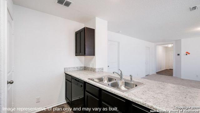 kitchen with dishwasher, light hardwood / wood-style floors, dark brown cabinets, and sink