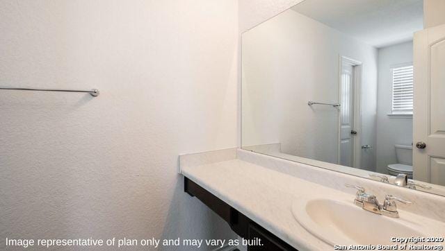 bathroom with vanity and toilet