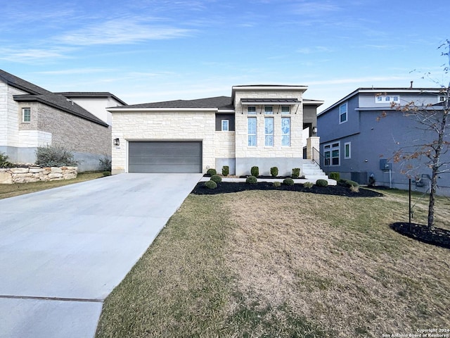 view of front of house with a garage and a front lawn