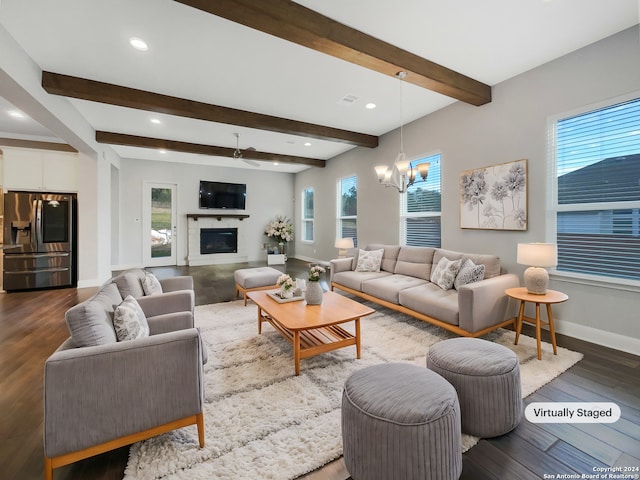 living room with beamed ceiling, dark hardwood / wood-style floors, and a healthy amount of sunlight