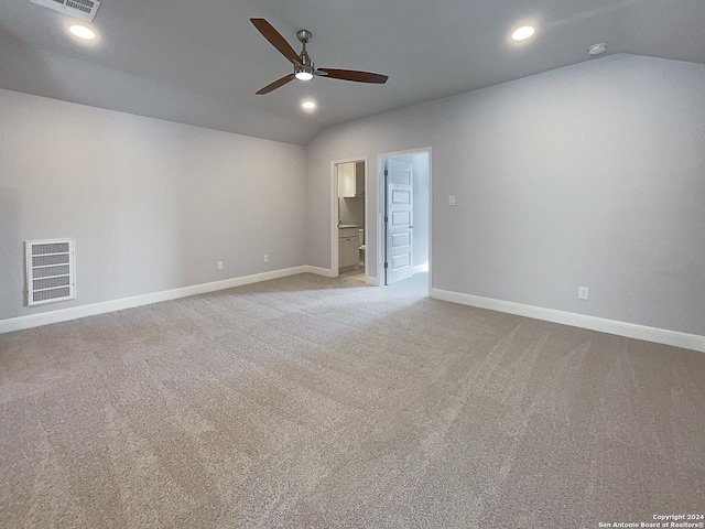 unfurnished room with ceiling fan, light colored carpet, and vaulted ceiling