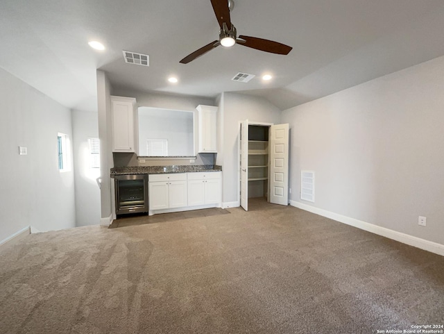 kitchen with carpet flooring, white cabinetry, ceiling fan, wine cooler, and lofted ceiling