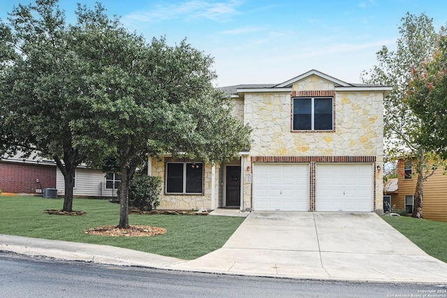 view of front of property featuring a garage, a front lawn, and central air condition unit