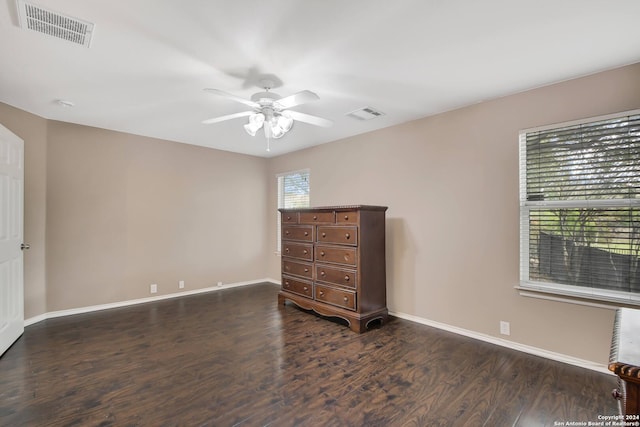 unfurnished bedroom featuring ceiling fan and dark wood-type flooring