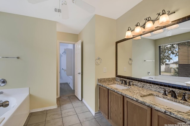 bathroom with tile patterned flooring, ceiling fan, a tub to relax in, and vanity