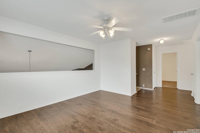 spare room with ceiling fan and dark wood-type flooring