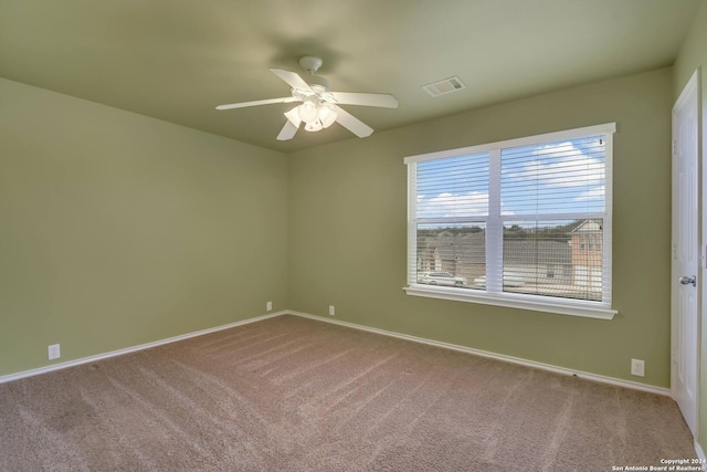 spare room featuring ceiling fan and carpet floors