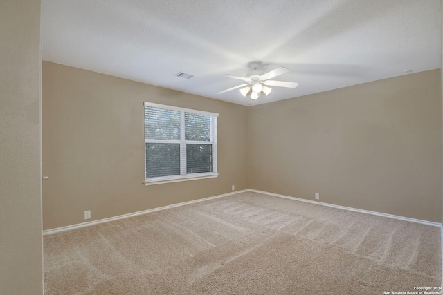 spare room with carpet floors and ceiling fan