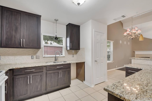 kitchen with a chandelier, plenty of natural light, hanging light fixtures, and sink