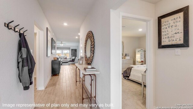 hallway with light hardwood / wood-style floors