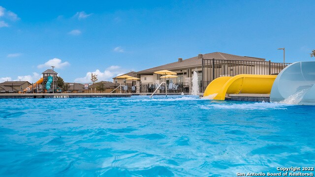 view of swimming pool with a water slide