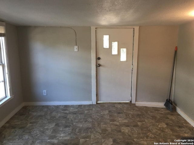 foyer entrance featuring a textured ceiling