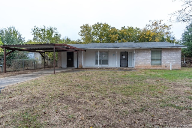 ranch-style home featuring a carport and a porch