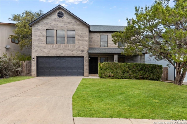 view of front facade with a garage and a front lawn