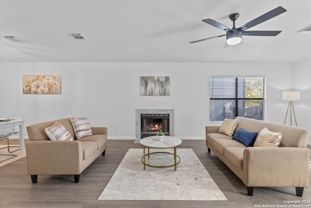 living room with ceiling fan and dark hardwood / wood-style floors