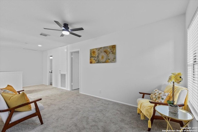 sitting room featuring light carpet and ceiling fan