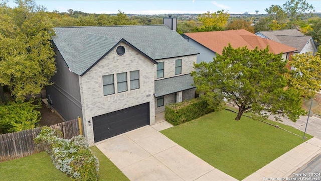 view of front of property with a garage and a front yard