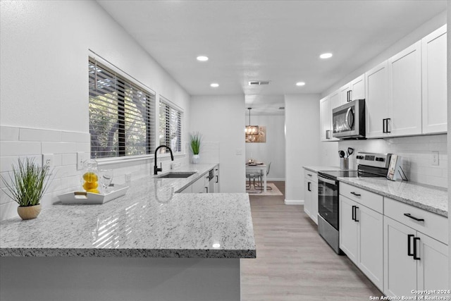 kitchen with white cabinets, stainless steel appliances, and sink