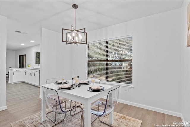 dining room featuring a chandelier and light hardwood / wood-style flooring