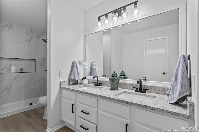 bathroom featuring hardwood / wood-style floors, vanity, toilet, and a shower with shower door