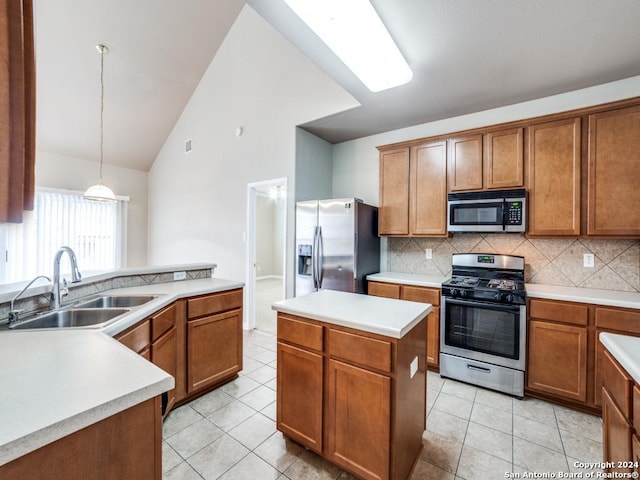 kitchen with appliances with stainless steel finishes, sink, light tile patterned floors, pendant lighting, and a center island