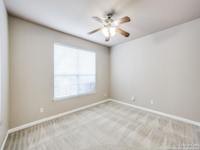 carpeted empty room featuring ceiling fan