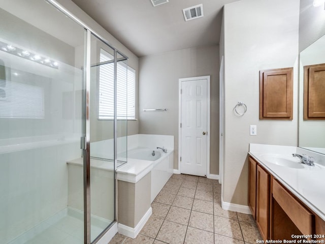 bathroom featuring tile patterned flooring, vanity, and shower with separate bathtub