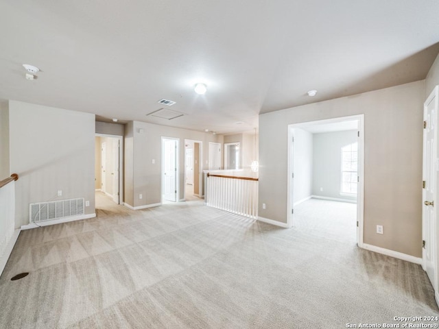 unfurnished living room featuring light carpet