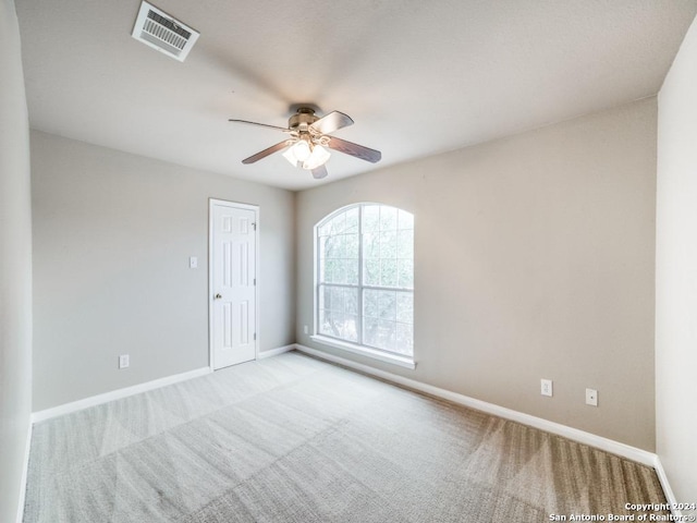 spare room featuring ceiling fan and light colored carpet