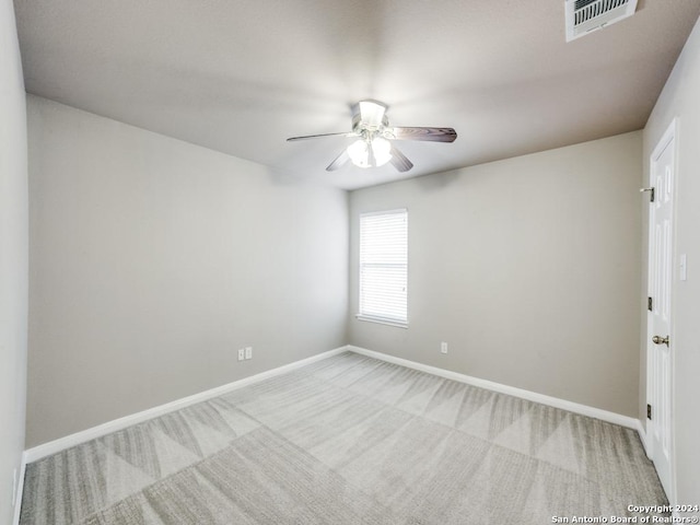 empty room with light colored carpet and ceiling fan