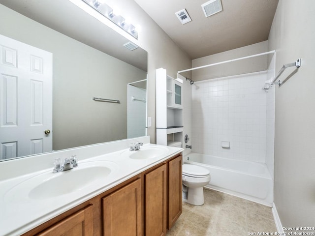 full bathroom featuring tile patterned flooring, vanity, tiled shower / bath combo, and toilet