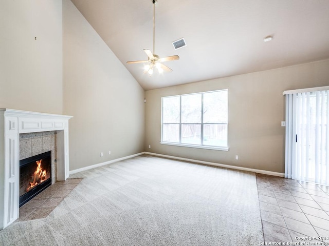 unfurnished living room featuring a fireplace, high vaulted ceiling, ceiling fan, and light tile patterned flooring