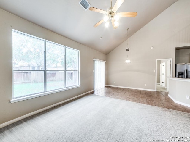 unfurnished living room with light colored carpet, high vaulted ceiling, and ceiling fan