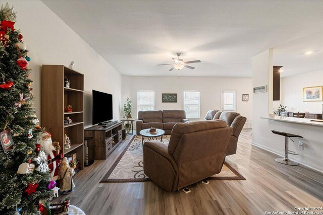 living room featuring ceiling fan and light wood-type flooring