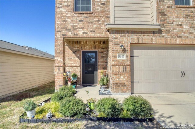 view of exterior entry with a garage