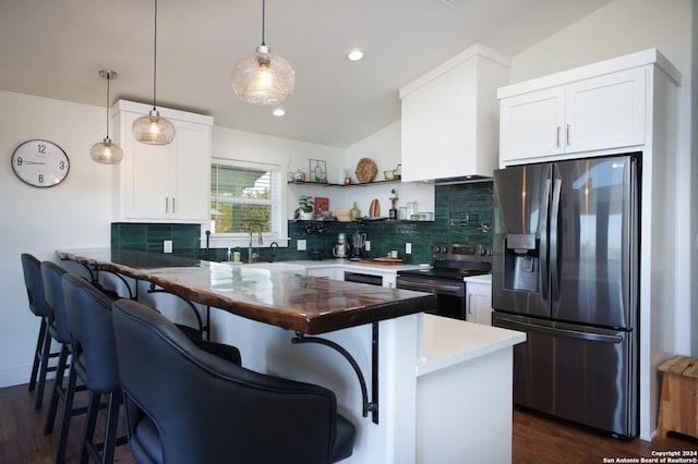 kitchen featuring pendant lighting, kitchen peninsula, white cabinetry, and stainless steel appliances