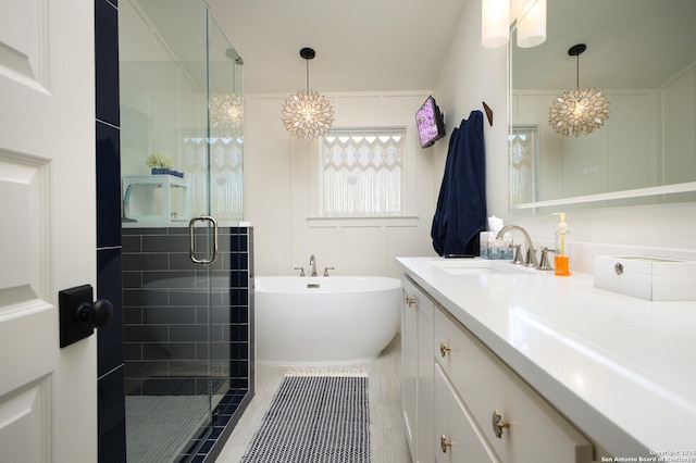 bathroom featuring tile patterned floors, separate shower and tub, vanity, and an inviting chandelier