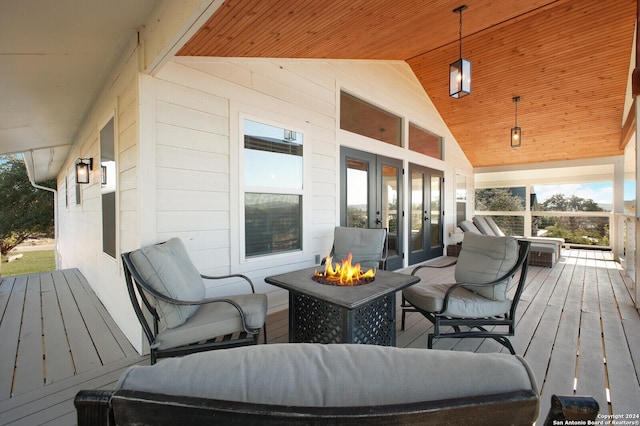 wooden terrace featuring an outdoor fire pit