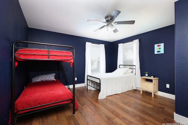 bedroom featuring ceiling fan and dark wood-type flooring