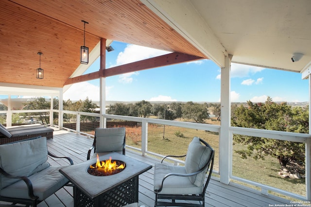 wooden deck with a fire pit