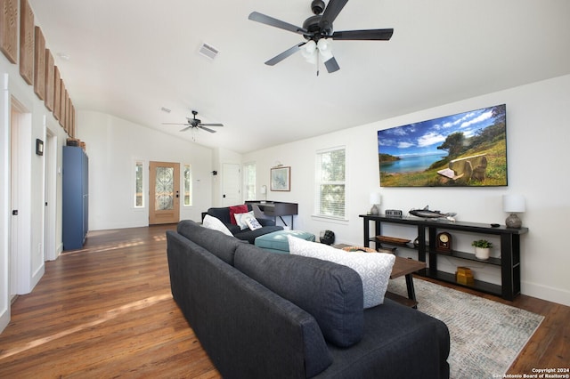 living room featuring ceiling fan, dark wood-type flooring, and vaulted ceiling