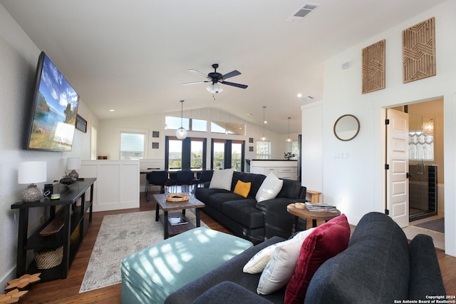 living room with dark hardwood / wood-style floors, ceiling fan, and lofted ceiling