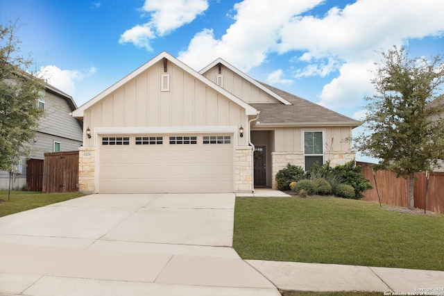 craftsman-style home featuring a garage, concrete driveway, stone siding, a front lawn, and board and batten siding