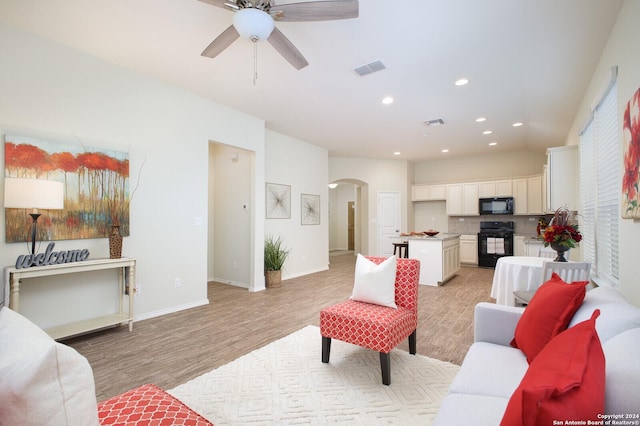 living room featuring ceiling fan and light hardwood / wood-style flooring