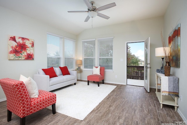 living room with vaulted ceiling, ceiling fan, plenty of natural light, and dark hardwood / wood-style floors