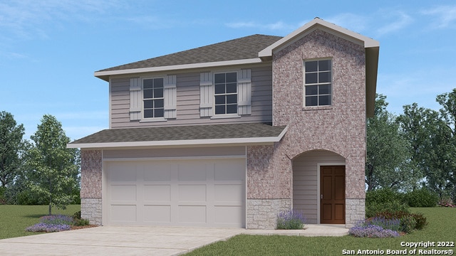 view of front of home featuring a garage and a front lawn