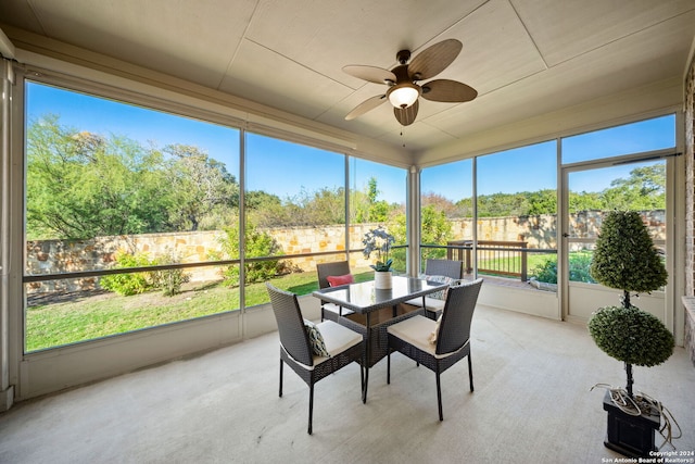 sunroom / solarium featuring ceiling fan