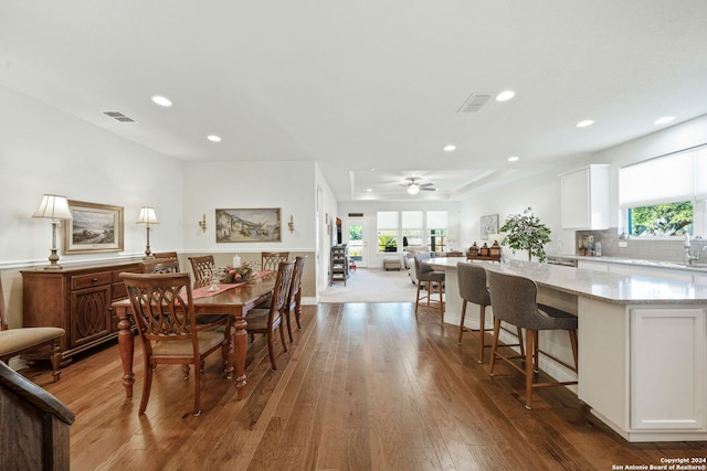 dining room with ceiling fan and dark hardwood / wood-style flooring